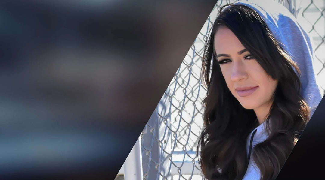 Woman with long dark hair in a light blue Origin sleeveless hoodie-crop.