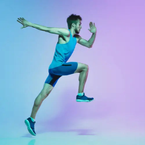 Athletic figure sprinting in turquoise tank top and blue shorts during holiday season fitness.